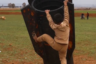 Verifying Viral Photo: Child Climbs Real Missile Booster in Syria